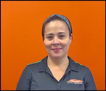 female employee with an orange background