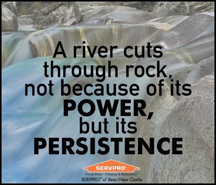 A river running over rocks with the text of a quote