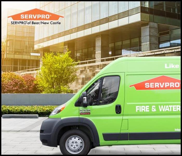 Green SERVPRO van out front of a commercial building