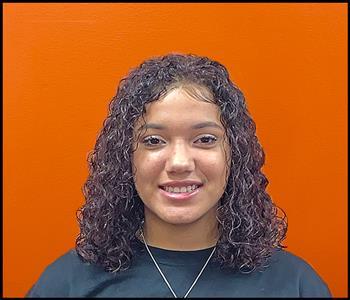 female employee with an orange background