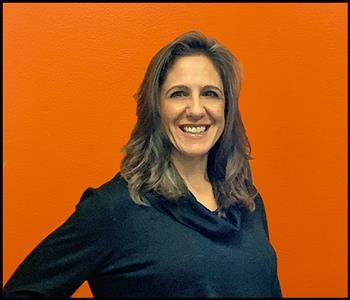 Image of a female employee with an orange background